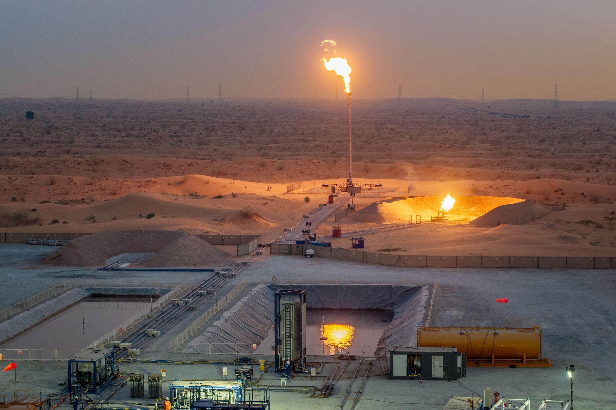 May be an image of fire, oil refinery and text