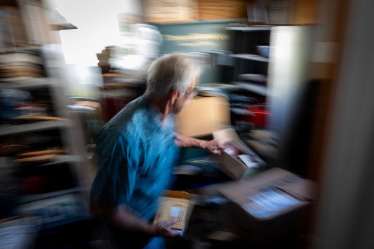 Christy Morrill, who lost decades of memories to autoimmune encephalitis, walks through his garage looking for old photos, Wednesday, Aug. 20, 2025, in San Carlos, Calif. (AP Photo/David Goldman)